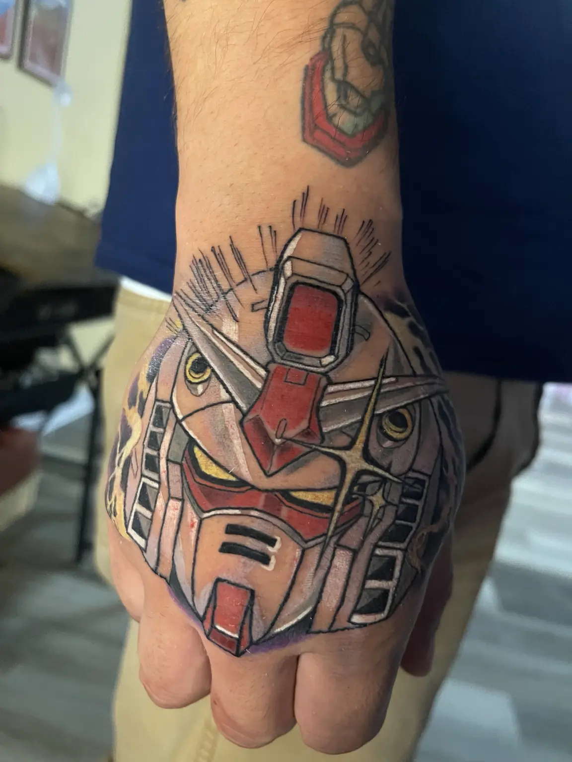 Full-color Gundam anime hand tattoo by Keith at Neo Tokyo Tattoos